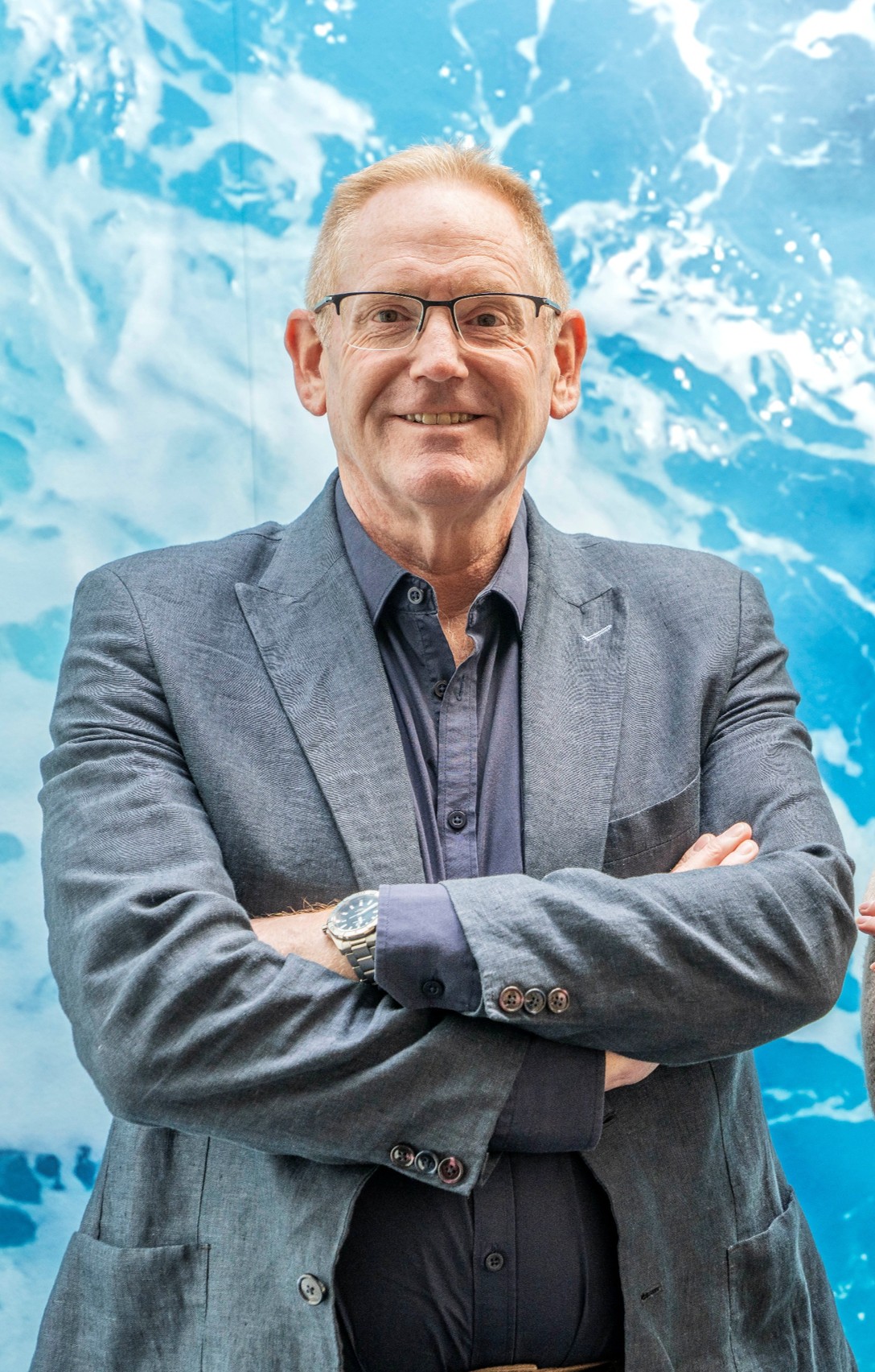 Mr Rod Shelley in front of blue wave feature wall